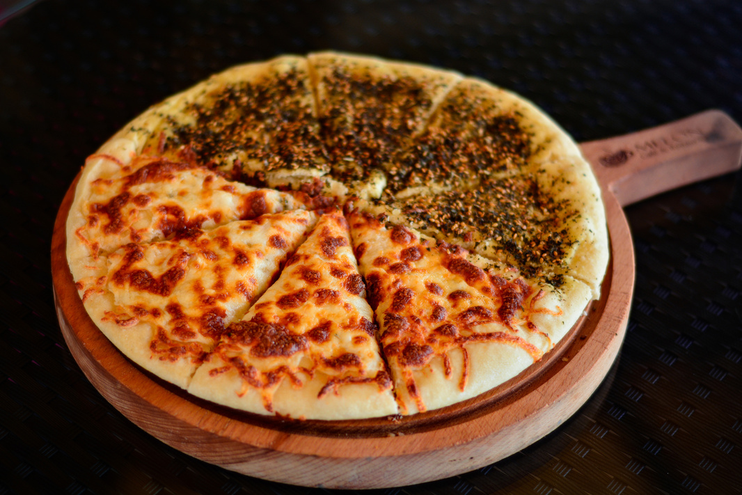 Pizza on Brown Wooden Round Plate